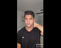 Two cats watch guy take shirt off 