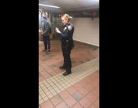 NYPD officers put handcuffs on guy in an orange inflatable T rex dinosaur suit and take a picture