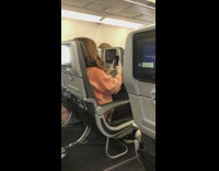 Face mask selfie airplane orange sweater lady 