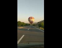 Hot air balloon float just above the road