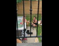 Red bikini girl brown dog jacuzzi backyard 