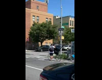 Guy walks with bike and tent 