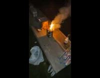Guy lights firework that starts shooting sparks towards him
