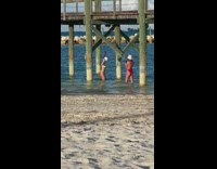Two women in bikini and white beach hat poses under the dock Part 2