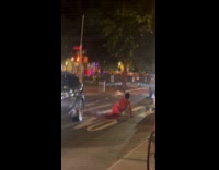 Guy spills water to man on street