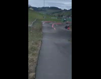 Guy rides bicycle up ramp jumps and falls 