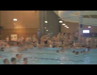 Divers dive into pool at same time 