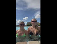 Girl spits pool water into friends mouth 