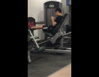 Guy glasses on phone leg day gym
