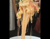 LOBSTER MAC and cheese eating from white plate