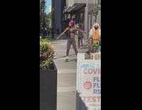 Guy purple head sack dance on street