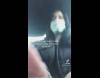Girl with handcuffs and blue mask on in car 