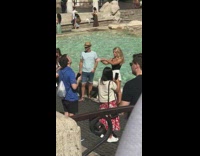 Girl poses at trevi fountain for fountains
