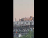 People stand and run on top of the train that moves