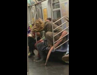 Guy brown rat costume squats subway seat