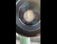 Telescope woman arm up front of castle