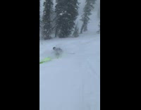 Skier neon green skis backflips up ramp and faceplants into snow