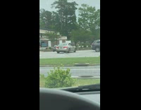 Man butt flex pose photo shoot beside car parking lot