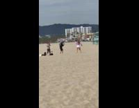 Girl dances on beach 