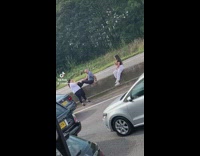 Girl grey pants sit barricade during traffic 