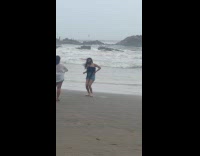 Woman tube top dances at the beach