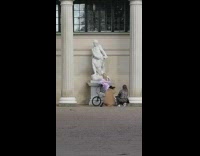 Pink dress woman statue columns pose