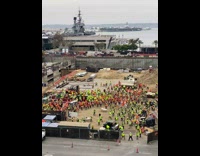 Construction workers do morning exercise at site