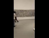 Guy walks around museum for photoshoot 