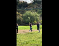 Tourists pose with Hollywood sign