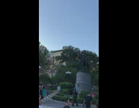 Guy climbs on top of George Washington statue in Union square