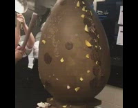 Chefs Break Giant Chocolate Egg with Metal Pots and Pans