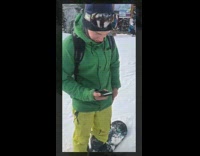green jacket yellow pants snowboarder lands on stomach