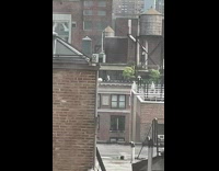 Collab WINY - Two people play volleyball on building rooftop