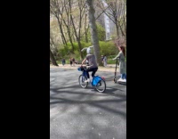 Man rides bike with a bunny headband