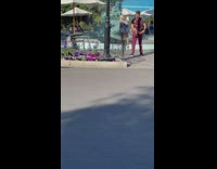 Woman blue shirt selfie beside water fountain