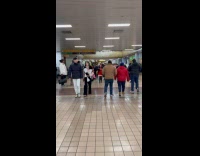 Grinch and Santa woman inside bus terminal