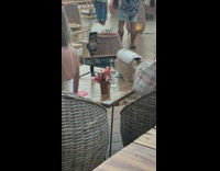 Lady takes self timer photos with tripod on table 