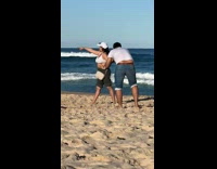 Collab IITW - Woman in white crop top points and poses at the beach