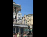 Woman blue outfit balcony pictorial wedding ceremony below