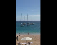 Woman bikini lunges beach boat white umbrella