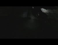 Woman swims inside a dark cave tunnel