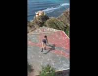 woman blue red stoop beach handstand