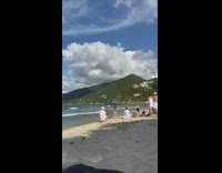 Women in their bikinis poses at the beach