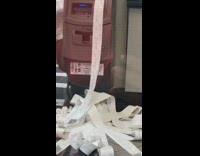broken atm printing a pile of receipts 