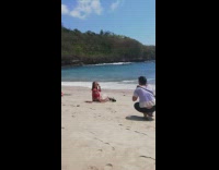 Woman red top dress sit beach pictorial