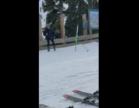 Man Dances Near Fence  and Ski Stand