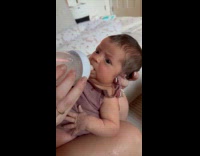 Baby first time drink milk from bottle