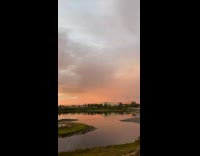 Sunset in the horizon with a rainbow arc on the other side