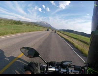 Guy riding motorcycle speeds past other motorcyclists 