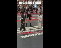 Boy cheers for younger sister during jiujitsu competition 